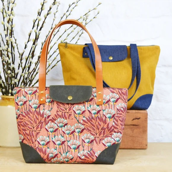 two handbag tote bags, one with a flower pattern, and the other with a yellow and blue fabric