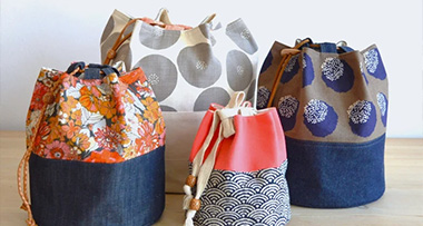 four different sizes of drawstring project bags sitting on a table